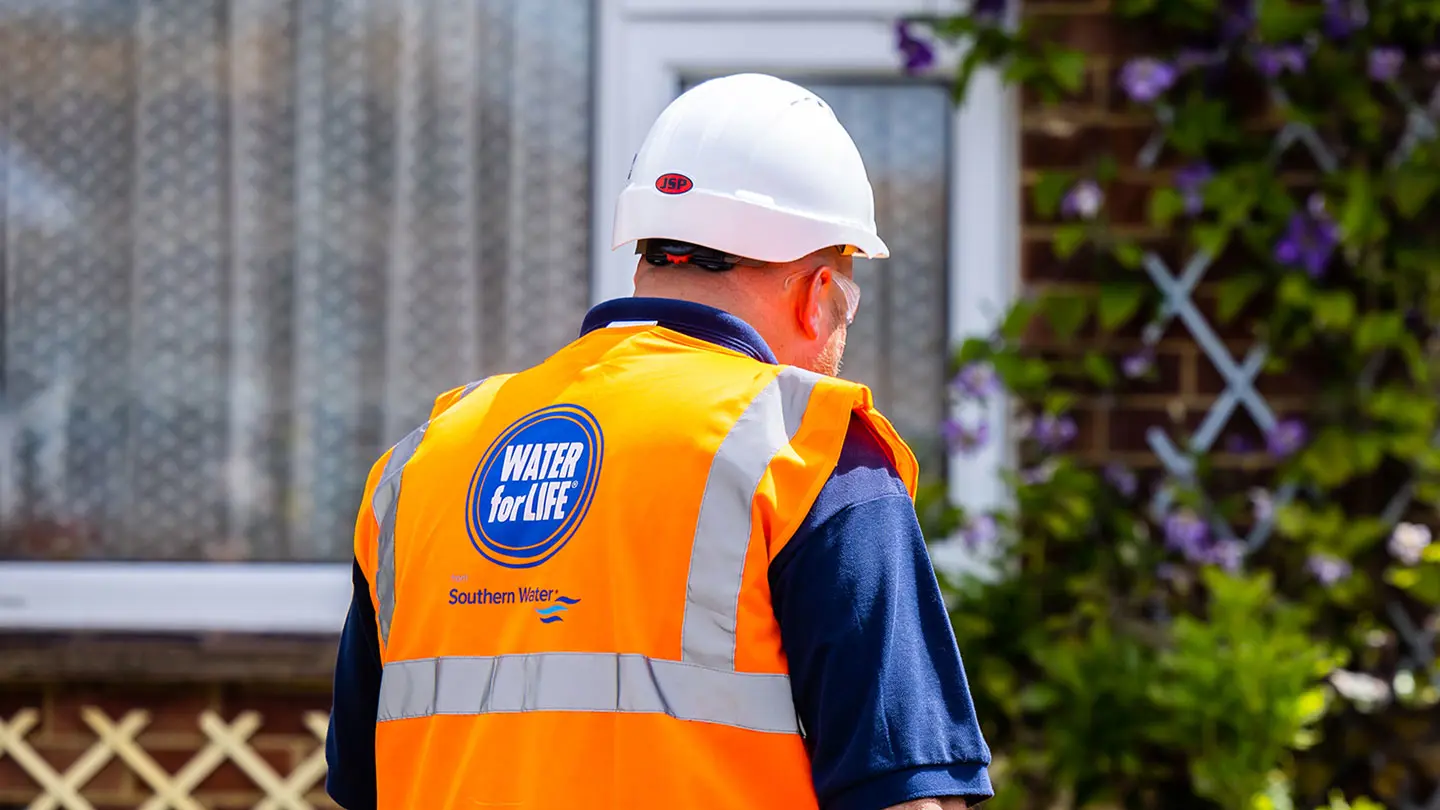 Southern Water team member in branded vest and hard hat