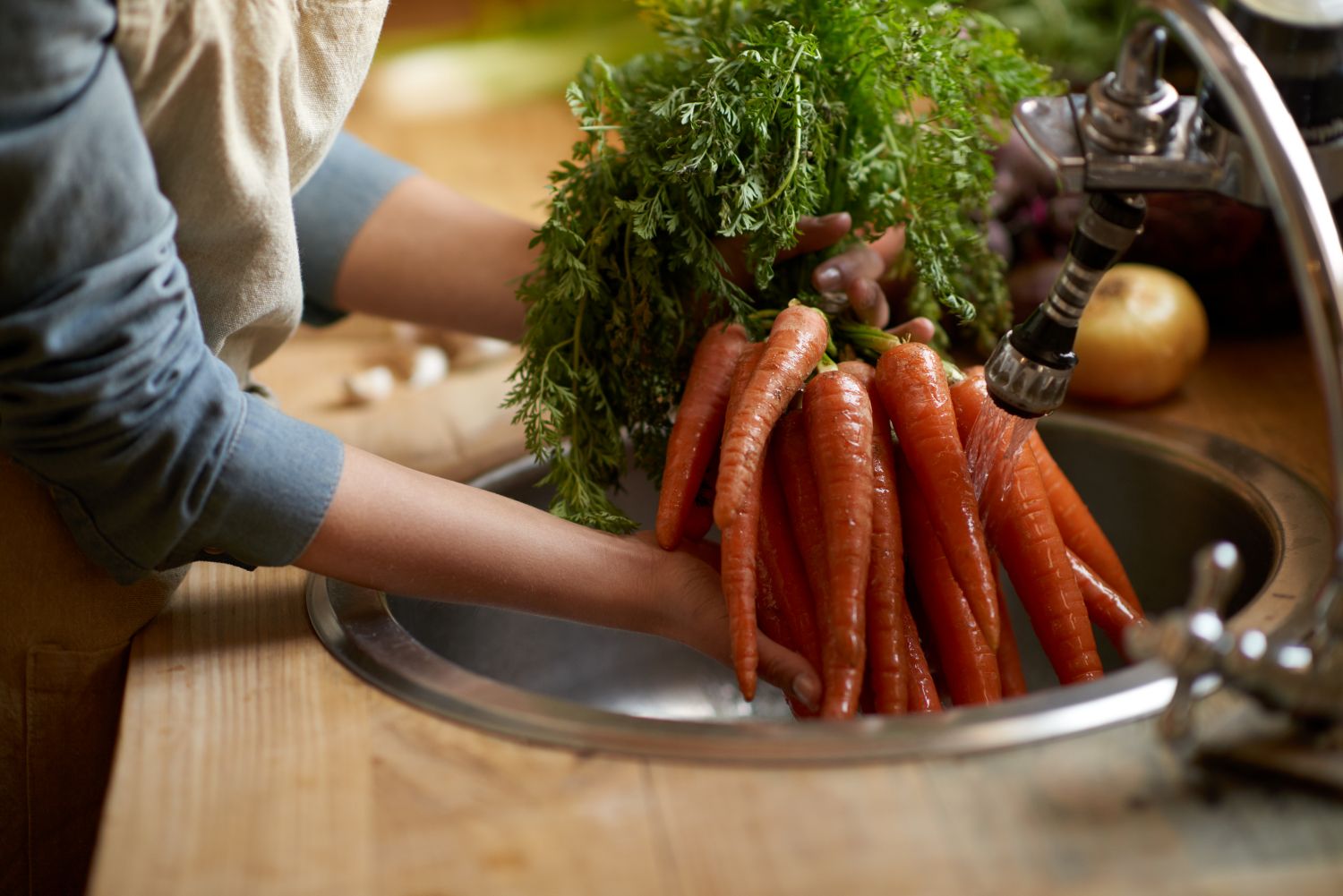 Washing carrots in the sink
